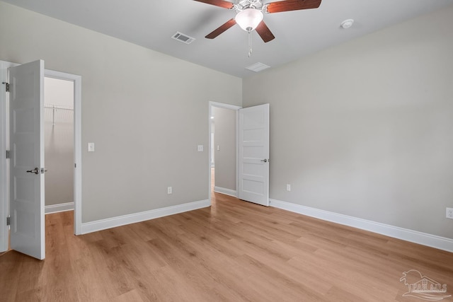 4420 Russell Elliott Rd, Jay, FL 32565 - unfurnished bedroom with a spacious closet, light wood-style floors, a closet, and baseboards