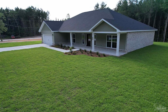4420 Russell Elliott Rd, Jay, FL 32565 - view of front of house with a porch, a garage, a front lawn, driveway, and roof with shingles