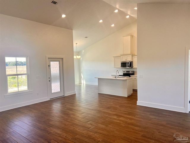 4420 Russell Elliott Rd, Jay, FL 32565 - unfurnished living room with high vaulted ceiling, a chandelier, a sink, baseboards, and dark wood-style flooring