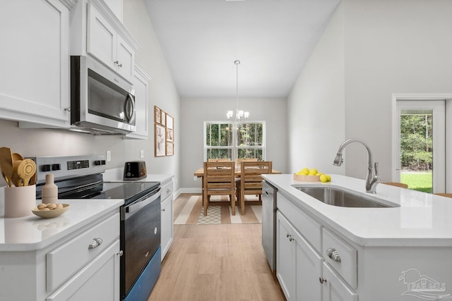 4420 Russell Elliott Rd, Jay, FL 32565 - kitchen featuring appliances with stainless steel finishes, a sink, light wood-style flooring, a chandelier, and vaulted ceiling