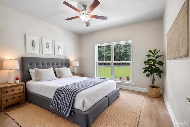 4420 Russell Elliott Rd, Jay, FL 32565 - bedroom featuring baseboards, light wood-style flooring, and ceiling fan