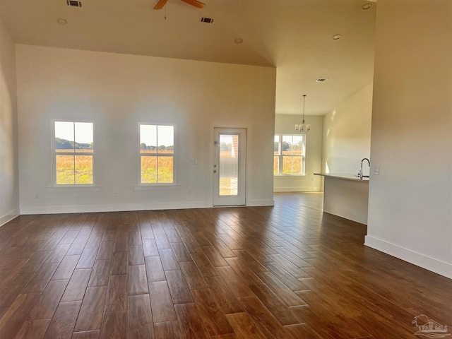 4420 Russell Elliott Rd, Jay, FL 32565 - unfurnished room with dark wood-style flooring, a ceiling fan, baseboards, a chandelier, and a sink