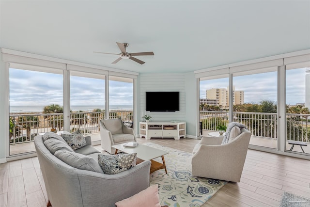 800 Ft Pickens Rd Unit 204, Pensacola Beach, FL 32561 - living room with light wood-type flooring, ceiling fan, a wall of windows, and a water view