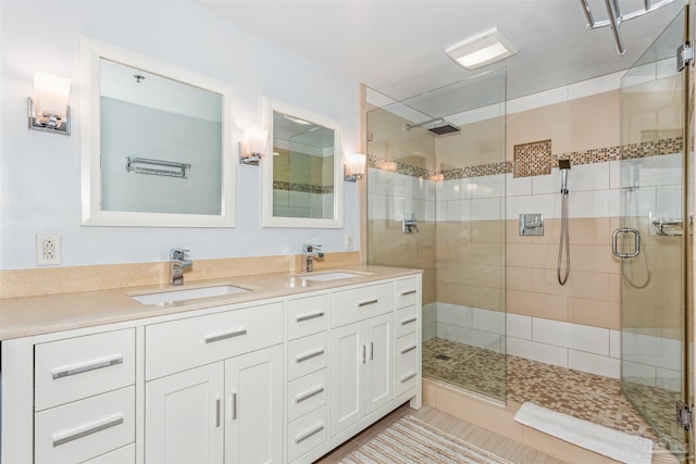 bathroom featuring vanity and a shower with door