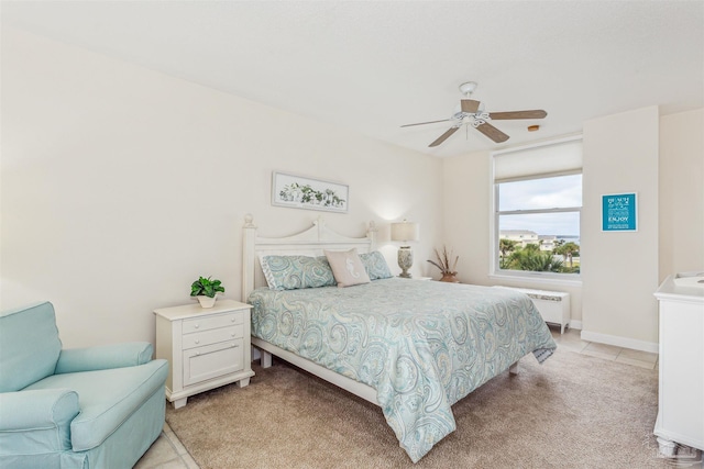 bedroom featuring ceiling fan, light tile patterned floors, and radiator