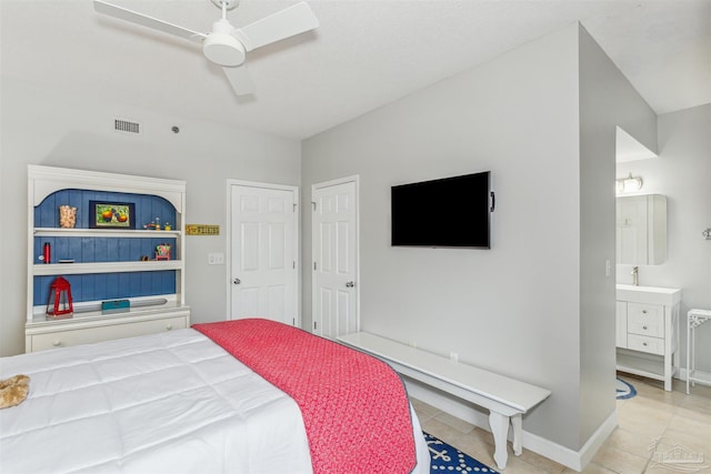 bedroom featuring ceiling fan, light tile patterned floors, and connected bathroom