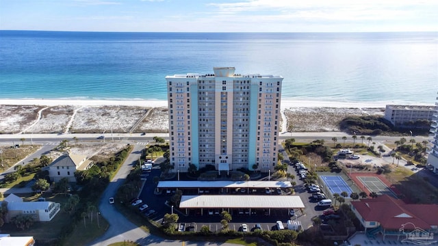 birds eye view of property with a water view and a view of the beach