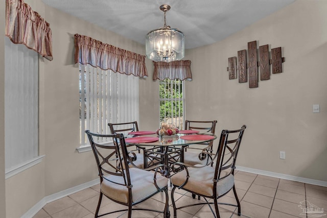 tiled dining room featuring a chandelier