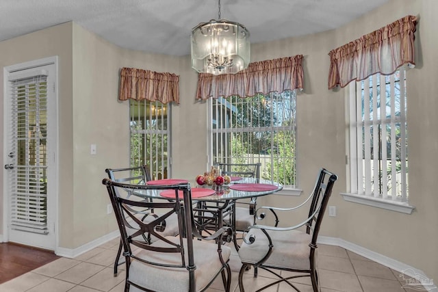 dining space featuring light tile patterned floors and a chandelier