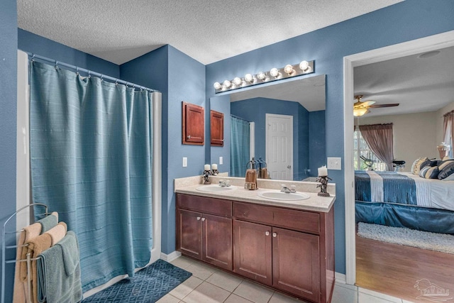 bathroom with vanity, a textured ceiling, tile patterned floors, and ceiling fan