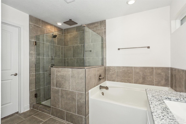 6610 Delhi Dr, Milton, FL 32583 - bathroom with a shower stall, tile patterned floors, a garden tub, vanity, and recessed lighting