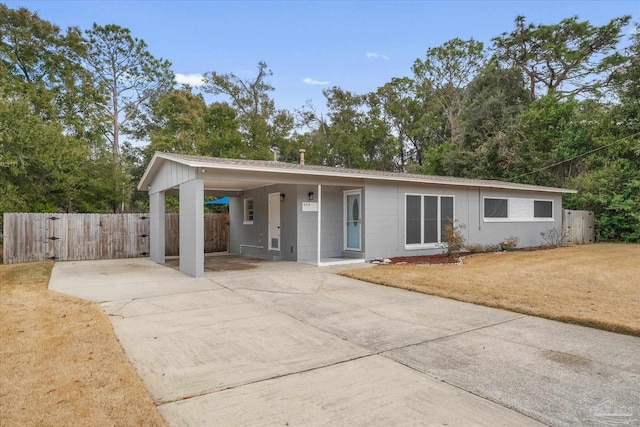 ranch-style house featuring a front lawn and a carport