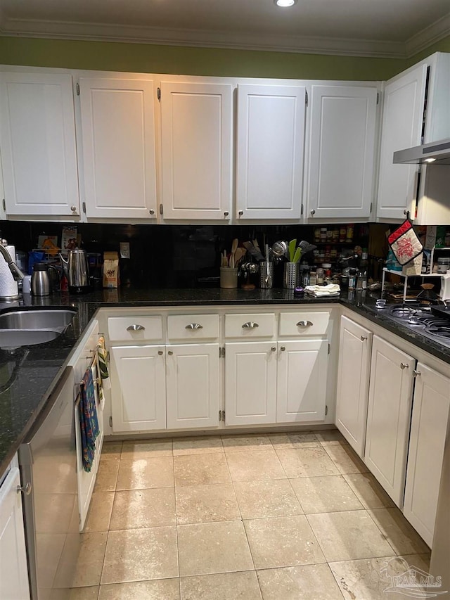 kitchen featuring sink, white cabinetry, dishwasher, dark stone countertops, and decorative backsplash