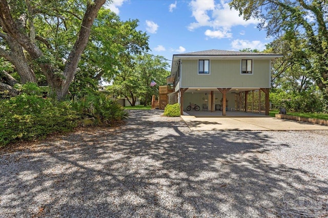 1948 Tanbark Dr, Milton, FL 32583 - view of side of property with driveway, stairs, and a carport