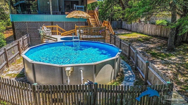 1948 Tanbark Dr, Milton, FL 32583 - view of swimming pool with stairs, a fenced backyard, and a wooden deck