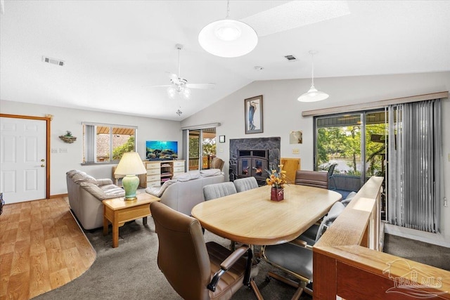 1948 Tanbark Dr, Milton, FL 32583 - dining area featuring vaulted ceiling, a ceiling fan, wood finished floors, and a high end fireplace
