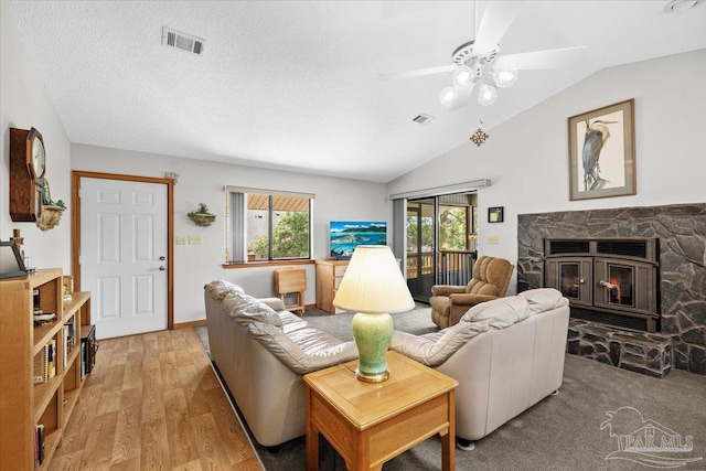 1948 Tanbark Dr, Milton, FL 32583 - living area with a fireplace, light wood finished floors, lofted ceiling, a ceiling fan, and a textured ceiling