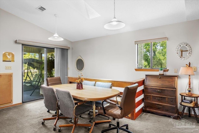 1948 Tanbark Dr, Milton, FL 32583 - carpeted dining space featuring vaulted ceiling, a skylight, and baseboards