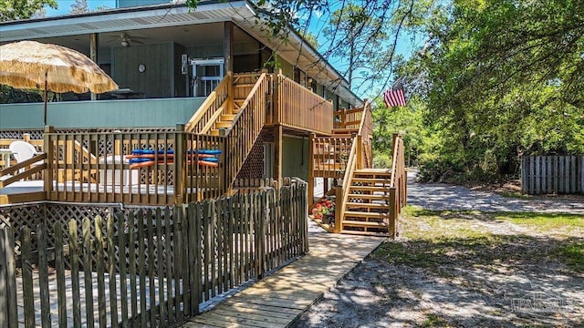 1948 Tanbark Dr, Milton, FL 32583 - view of playground with stairs, ceiling fan, and a wooden deck