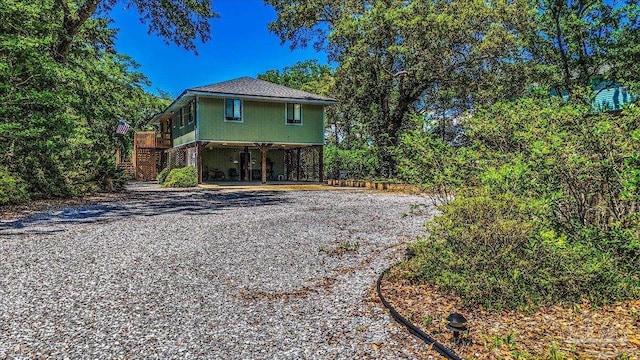 1948 Tanbark Dr, Milton, FL 32583 - view of property exterior featuring stairway, a carport, and driveway