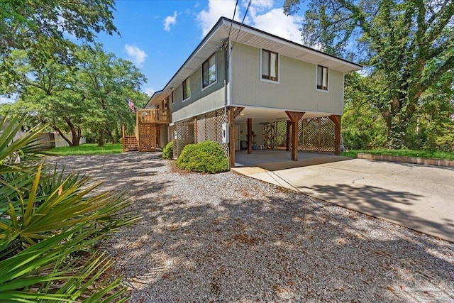 1948 Tanbark Dr, Milton, FL 32583 - view of property exterior with concrete driveway, stairway, and a carport