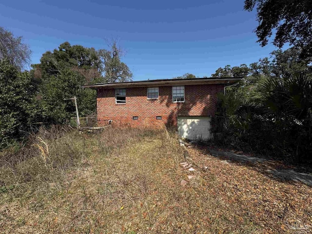 view of side of home with a garage