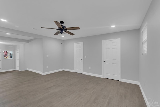 empty room with hardwood / wood-style flooring and ceiling fan