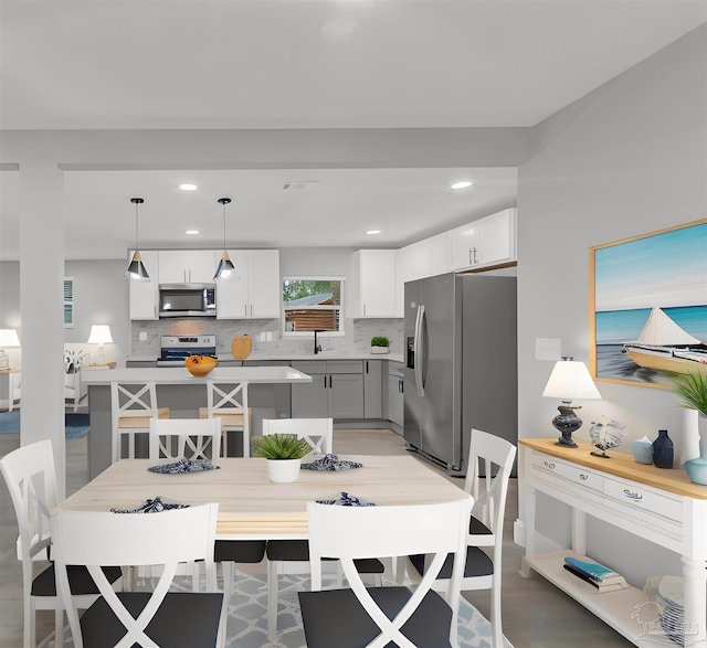 dining room with light hardwood / wood-style floors and sink