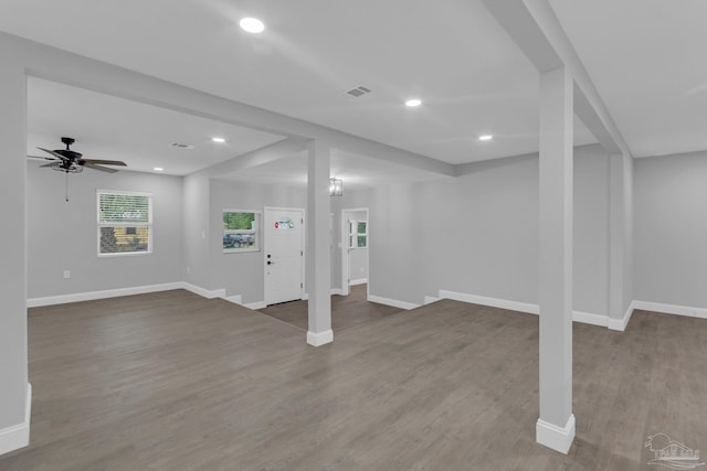 basement featuring hardwood / wood-style floors and ceiling fan