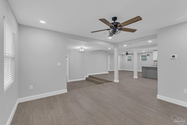 unfurnished living room with ceiling fan and wood-type flooring