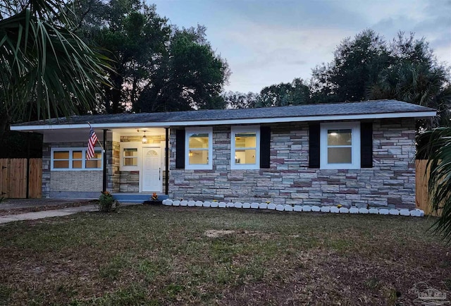 ranch-style home featuring a front yard