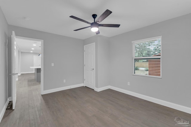 unfurnished bedroom with dark hardwood / wood-style flooring and ceiling fan