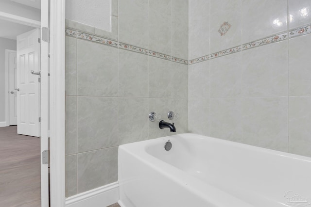 bathroom featuring hardwood / wood-style floors and a tub