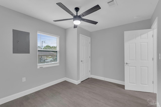 unfurnished bedroom featuring electric panel, wood-type flooring, and ceiling fan