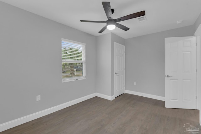 unfurnished bedroom featuring ceiling fan and dark hardwood / wood-style floors