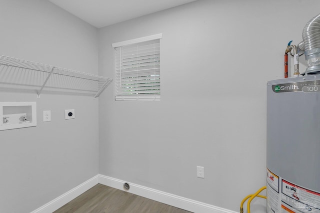 laundry area featuring dark wood-type flooring, washer hookup, water heater, and hookup for an electric dryer