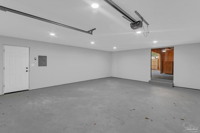 garage featuring a garage door opener and electric panel