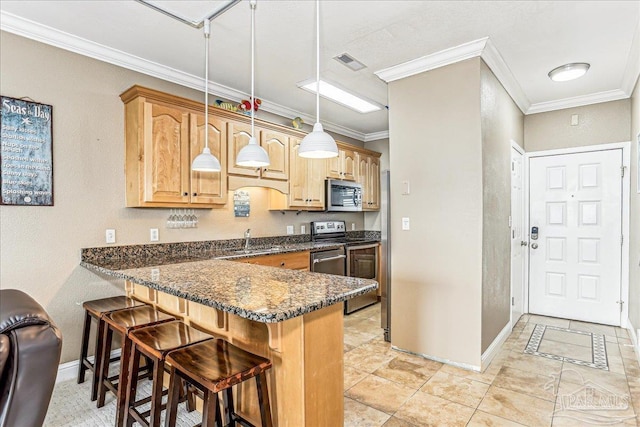 1150 Ft Pickens Rd Unit C7, Pensacola Beach, FL 32561 - kitchen featuring stainless steel appliances, a breakfast bar, baseboards, a peninsula, and crown molding