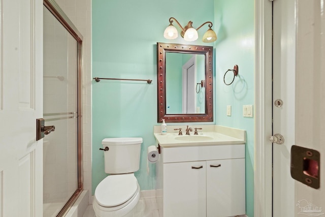 bathroom with vanity, toilet, tile patterned floors, and walk in shower