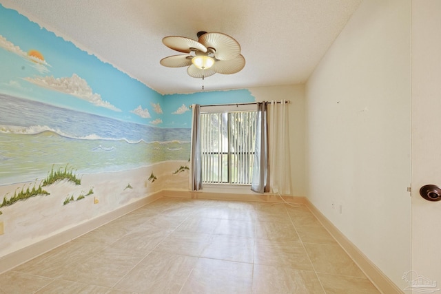 2715 Masters Blvd, Navarre, FL 32566 - empty room featuring a ceiling fan, a textured ceiling, and light tile patterned floors