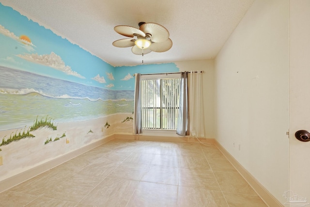 unfurnished room with a textured ceiling, ceiling fan, and light tile patterned flooring