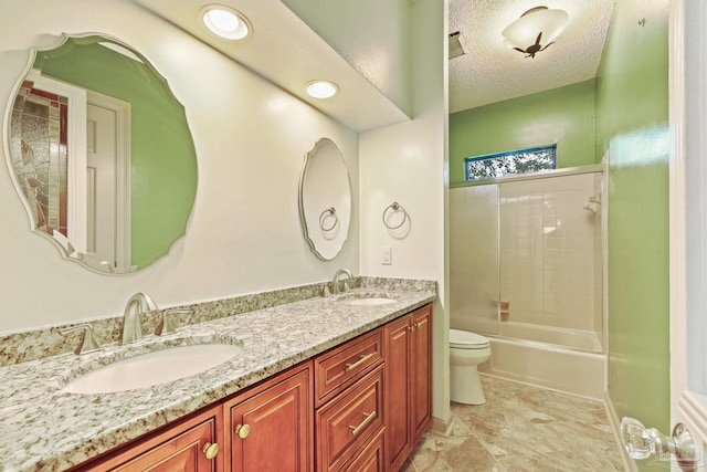 full bathroom featuring a textured ceiling, vanity, toilet, and tub / shower combination