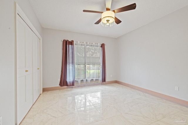 2715 Masters Blvd, Navarre, FL 32566 - unfurnished bedroom with light marble finish floors, a closet, and ceiling fan