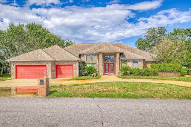 view of front of home featuring a front yard and a garage