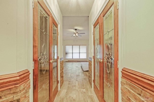 2715 Masters Blvd, Navarre, FL 32566 - hall with french doors and a textured ceiling