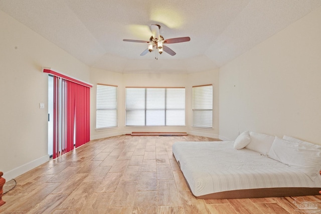 unfurnished bedroom featuring a textured ceiling, ceiling fan, and light wood-type flooring