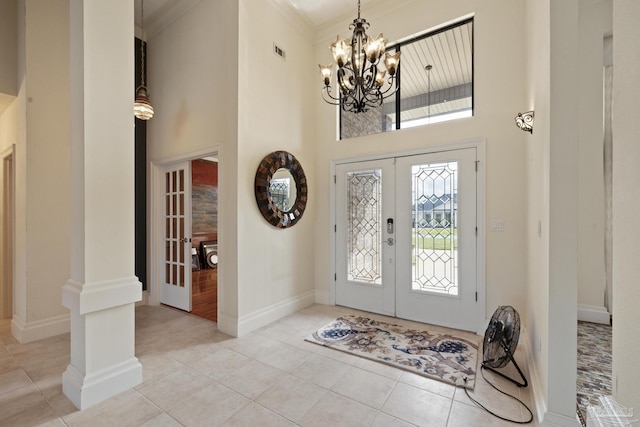 2715 Masters Blvd, Navarre, FL 32566 - tiled entryway featuring french doors, a high ceiling, a chandelier, and ornamental molding