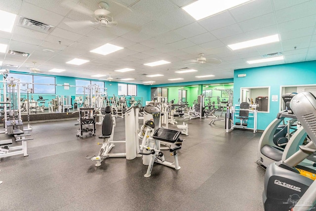 exercise room featuring a paneled ceiling and ceiling fan