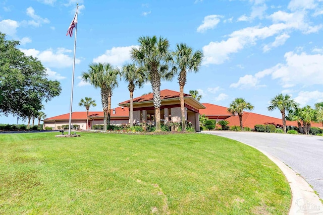 2715 Masters Blvd, Navarre, FL 32566 - view of front facade with a front yard and a garage