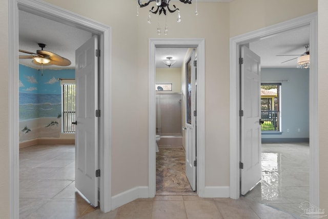 2715 Masters Blvd, Navarre, FL 32566 - corridor featuring a chandelier and light tile patterned floors